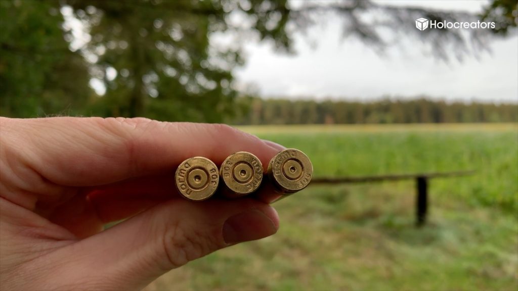 Swann Rack is holding three bullet casings between his fingers